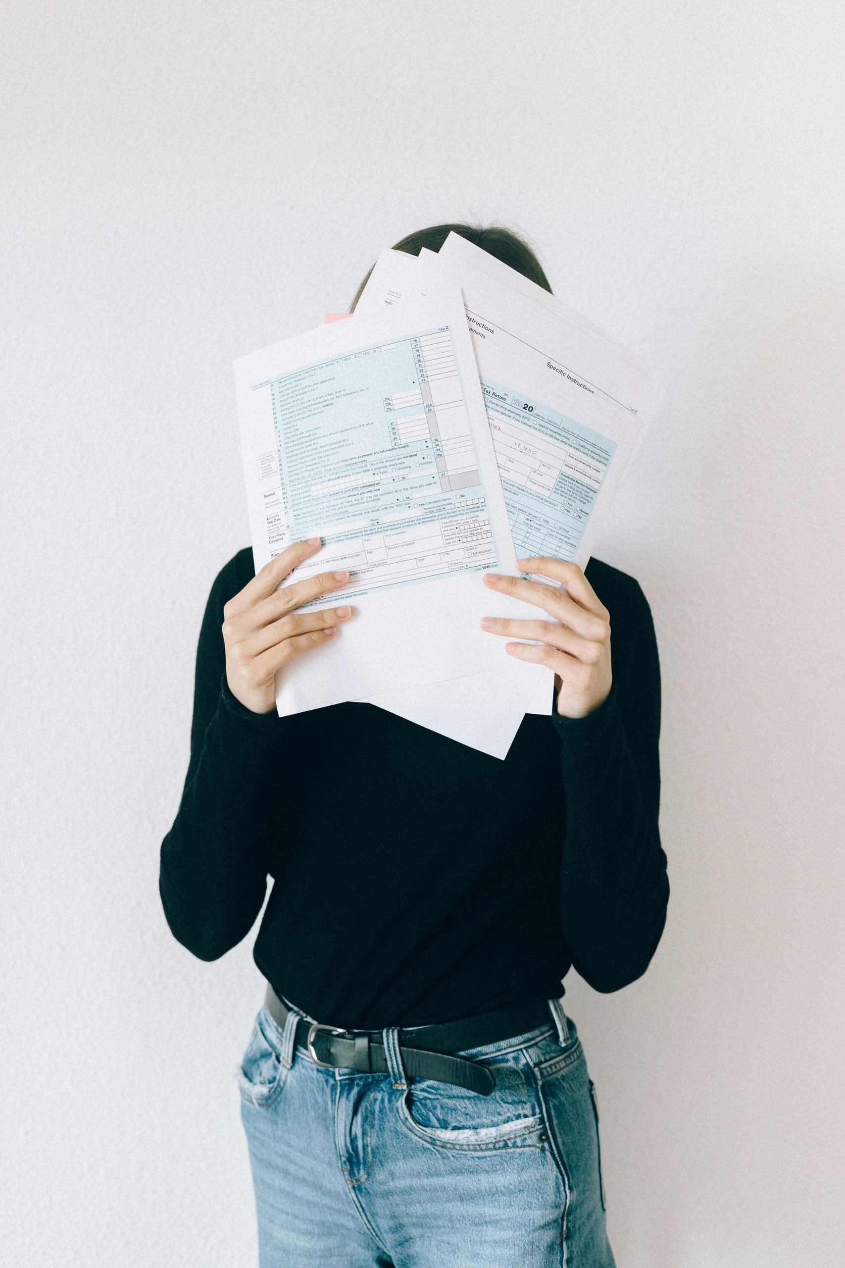 Person holding up debt collection paperwork — unsure and overwhelmed (legal guide concept)